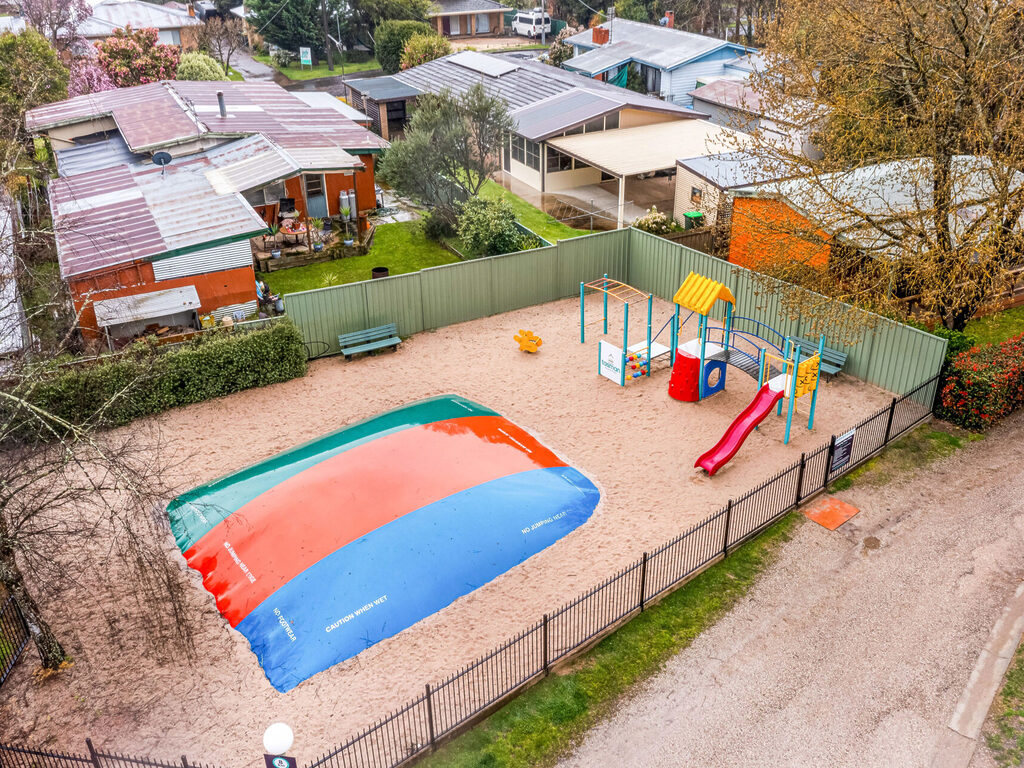 Aerial view of facilities at Tasman Holiday Parks South Bright including jumping pillow and playground