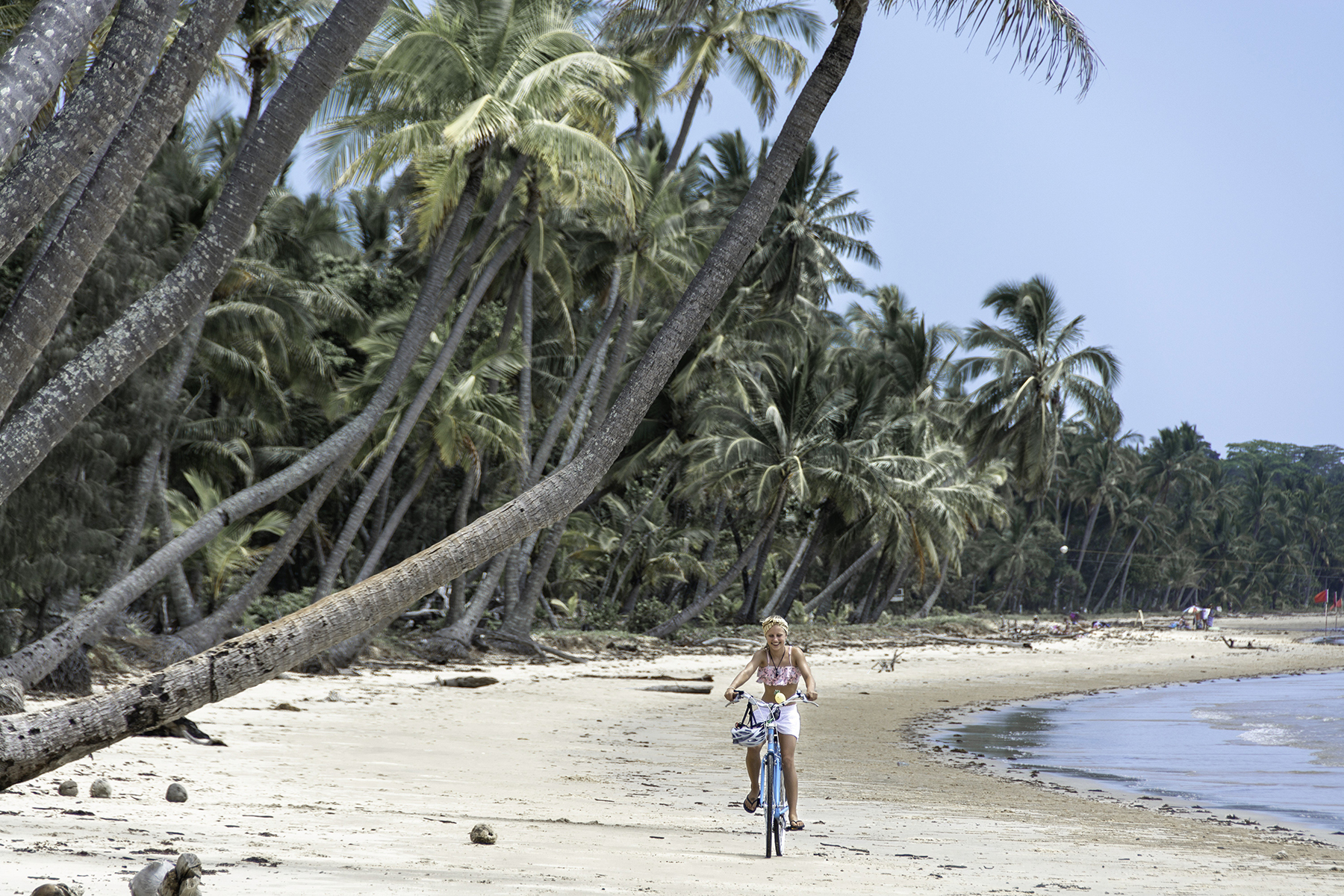 Woman riding a bike along the beach | South Mission Beach