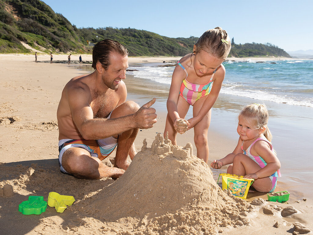 Family Playing in the sand at Nambucca Beach