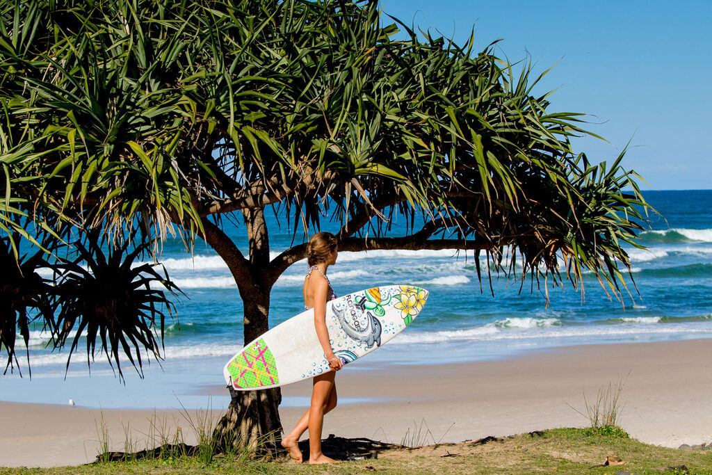 Surfer Girl at Sharpes Beach | Tasman Holiday Parks - Ballina