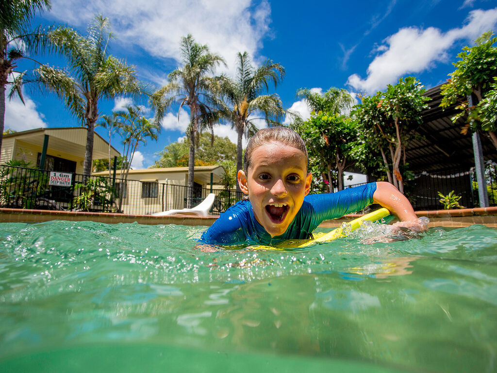 Kid in the swimming pool | Tasman Holiday Parks - Hervey Bay