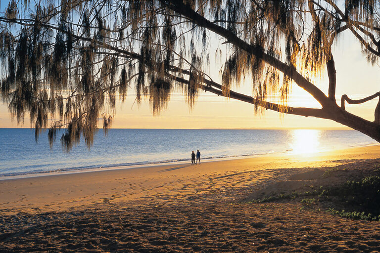 Couple Walking along the beach after sunrise | Hervey Bay Tasman Holiday Parks