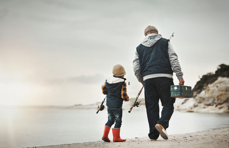 Walking, back and child with grandfather for fishing, bonding and learning to catch fish at the beach.
