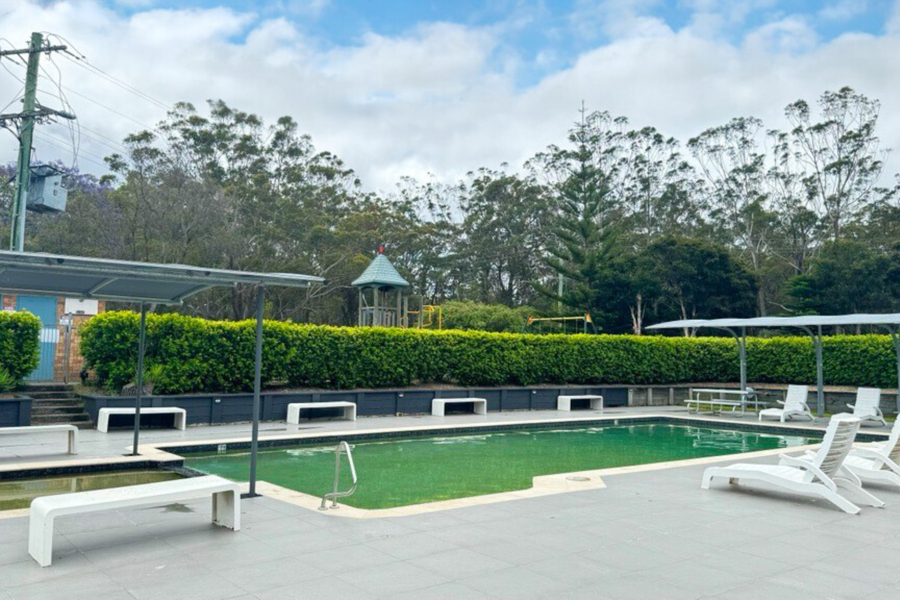 Swimming pool with sun loungers at Tasman Holiday Parks Myola