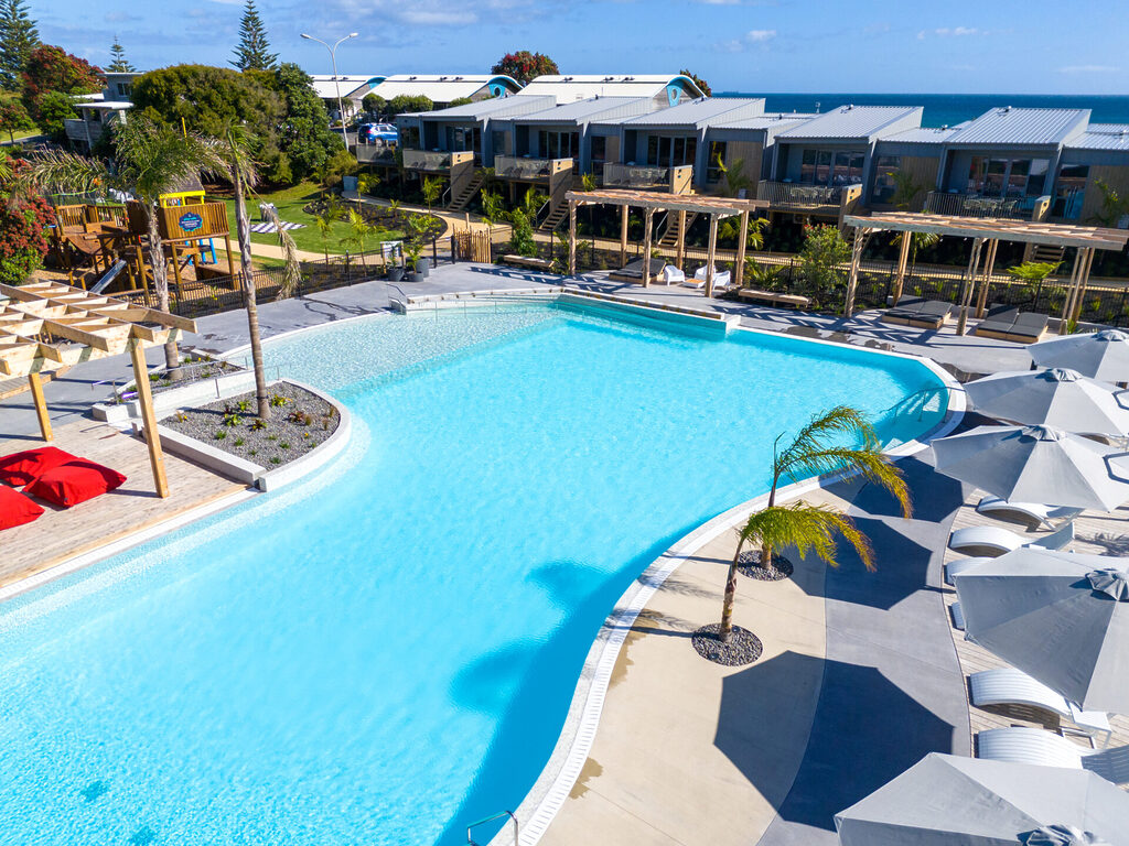 Papamoa Beach aerial showcasing pool and villas | Tasman Holiday Parks Papamoa Beach