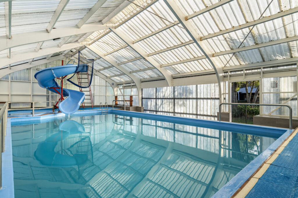 A indoor pool with a slide and a slide in it.