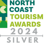 Logo for the North Coast Tourism Awards 2024. It features text "North Coast Tourism Awards" in bold green and blue letters with a stylized geometric design on the left. Below, it reads "2024 SILVER" in grey letters with a silver underline.