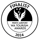 A circular logo with "FINALIST" at the top. Below is a black and white design featuring a stylized swan with stars above it. The text reads "PERTH AIRPORT WA TOURISM AWARDS 2024." The entire logo is outlined with a black circle.