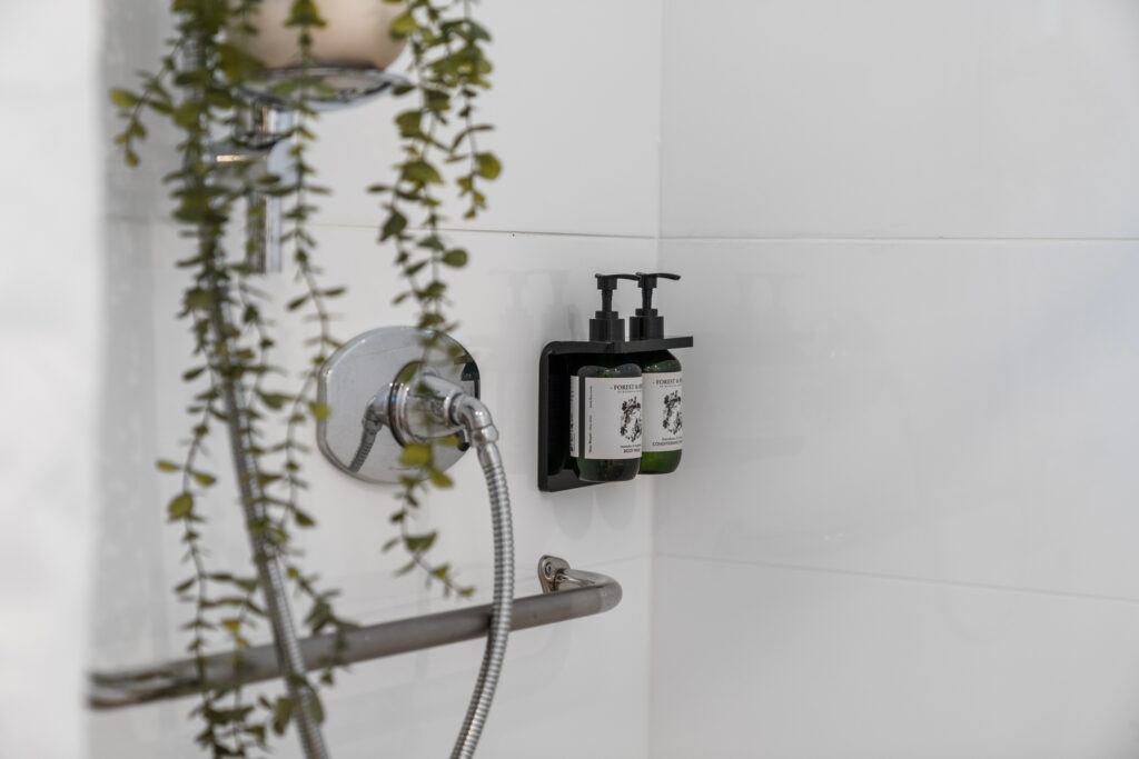 Experience a refreshing cleanse with our new shower, featuring a sleek shower head and convenient soap dispenser.