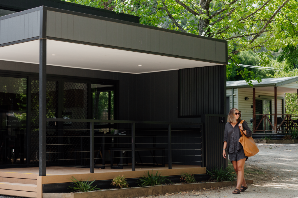 Woman walking past Villa (3BR) | Tasman Holiday Parks - South Bright